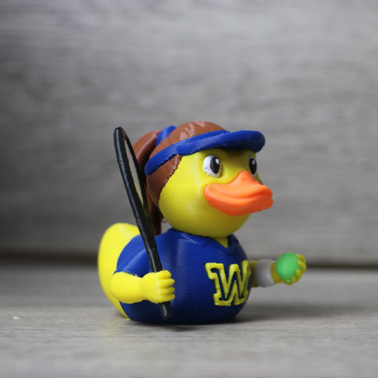 Rubber duck dressed as a tennis player with a blue outfit and 'W' logo on a gray background