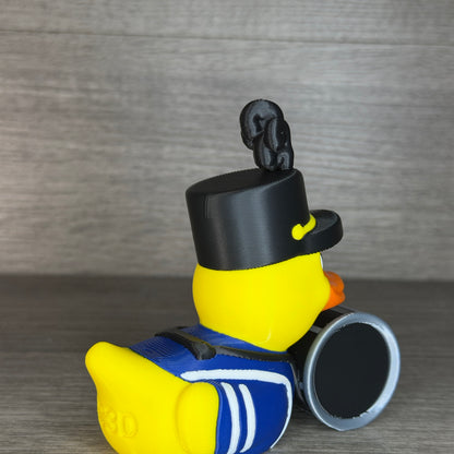 Rear three-quarter view of the band drummer duck showing the drum harness straps and CC3D engraved on the tail