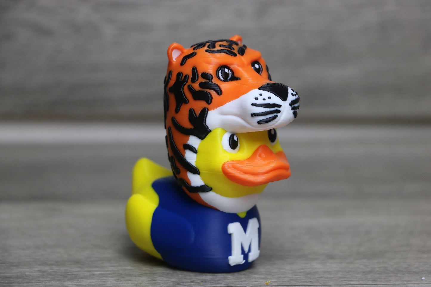 Rubber duck with tiger head design on a gray background
