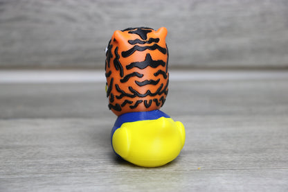 Toy figure with tiger head and yellow body on a gray background