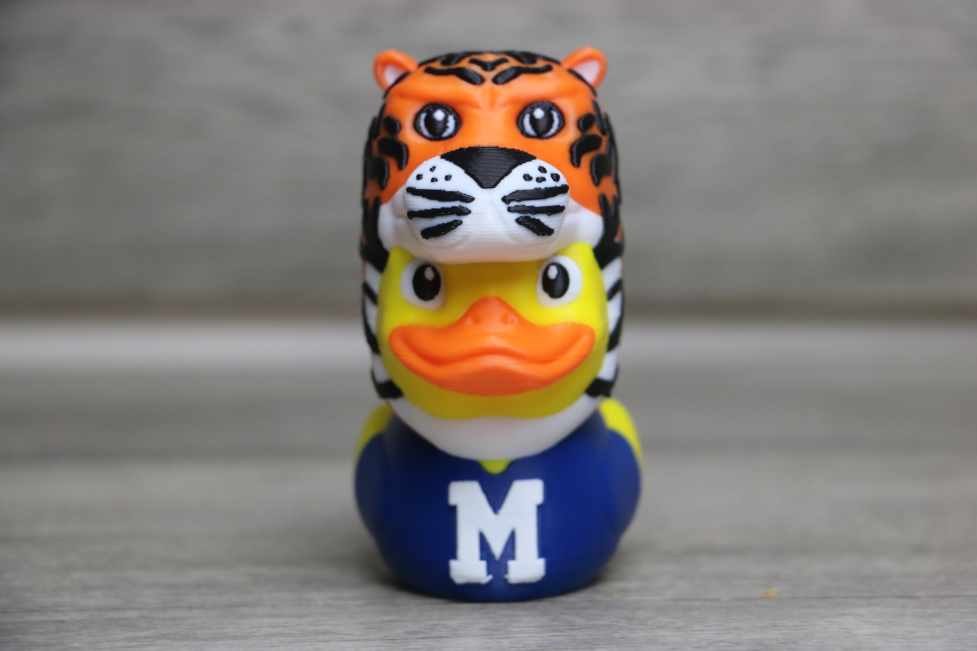 University of Memphis duck front view in tiger costume with navy blue jersey