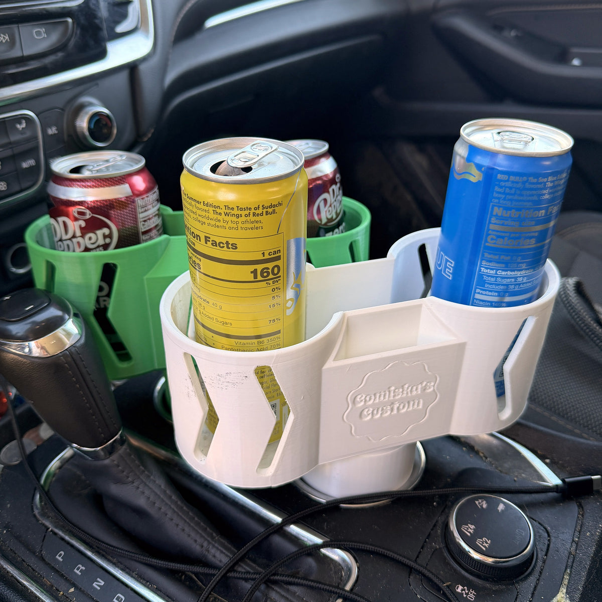 Dual car cup holder expander holding two cans in an SUV center console