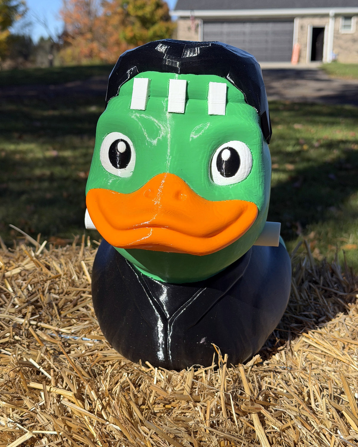 Giant Franken-Duck 12 inch 3D printed Frankenstein duck, front view on a hay bale