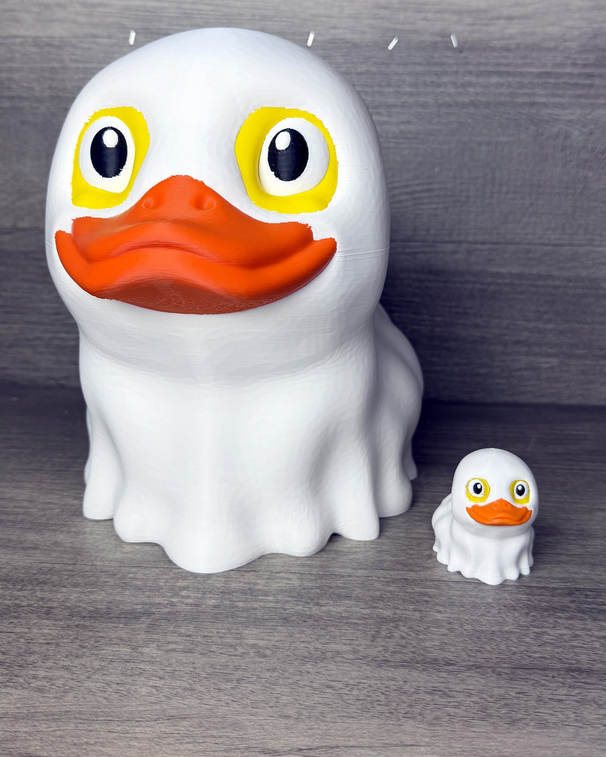 Giant Ghost-Duck next to a regular-size ghost duck for size comparison
