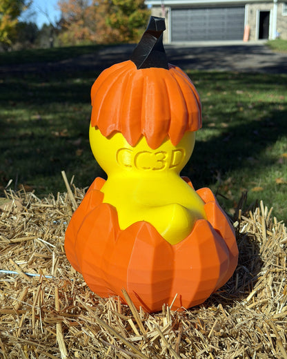 Giant Jack O Lantern Duck back view with pumpkin hat and CC3D logo, outdoors on a hay bale