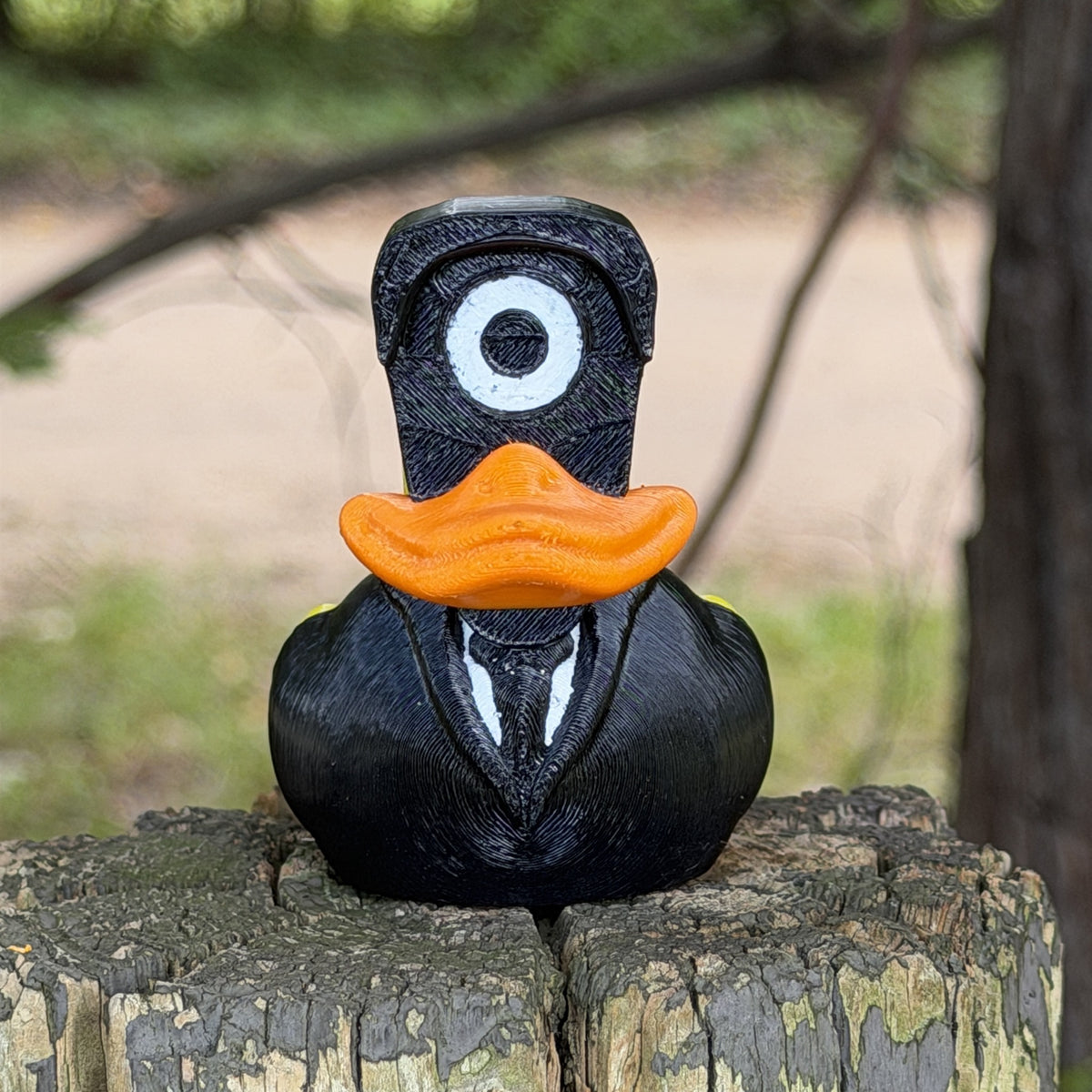 Spy Duck 3D printed duck in black suit with camera lens head, front view